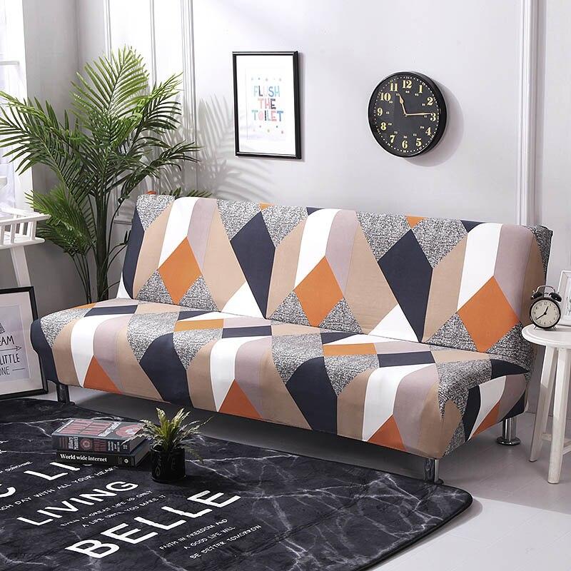Funda de sofá cama clic clac elástica, Patchwork naranja y marino, colocada en un sofá cama clic clac