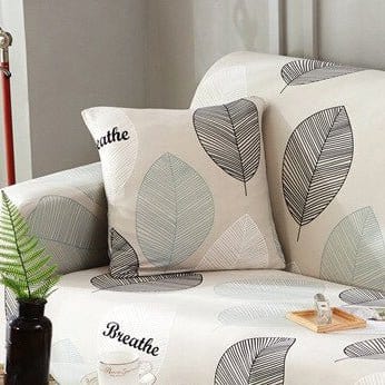 Fundas de cojín elásticas 45 × 45 cm — pack de 2, Crudo con follaje gris, colocadas en un sofá